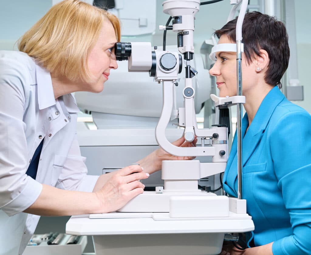Checking adult woman vision with ophthalmic equipment